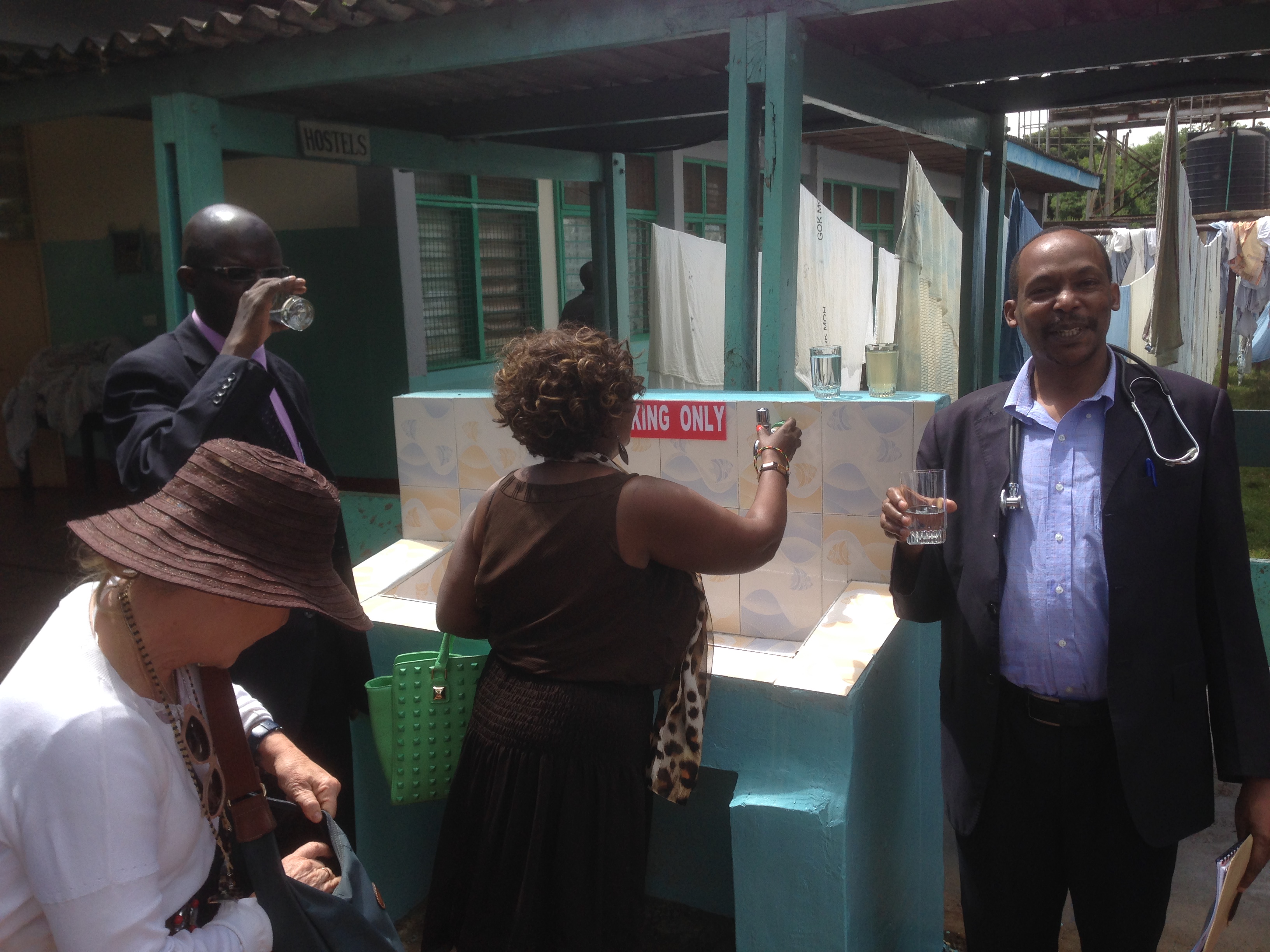 Dr Ngigi director of hospital cheering with safe water
